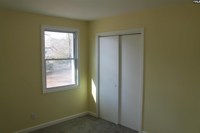 unfurnished bedroom featuring a closet and carpet flooring