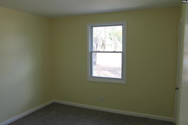 empty room featuring dark colored carpet