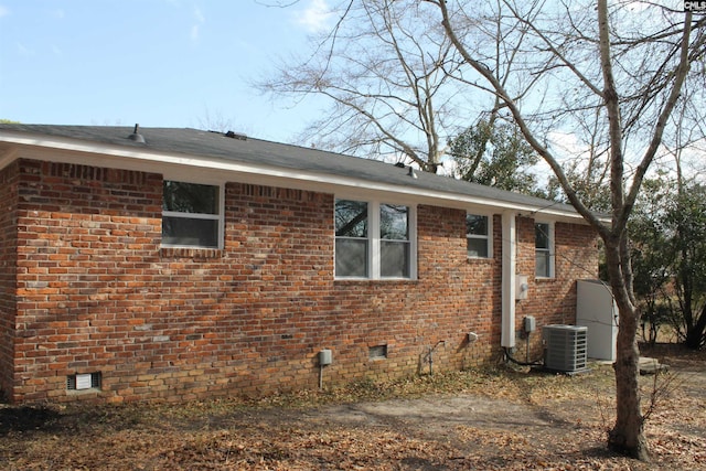 back of house with central AC unit