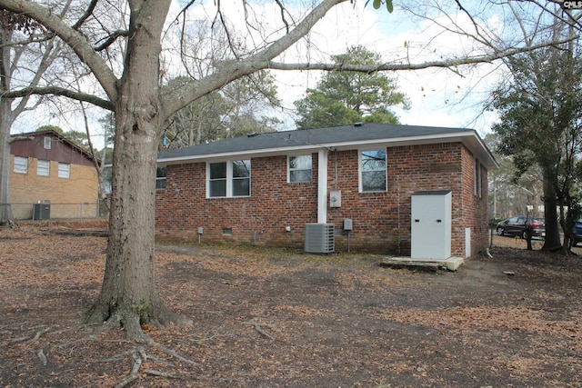 back of house with central AC unit