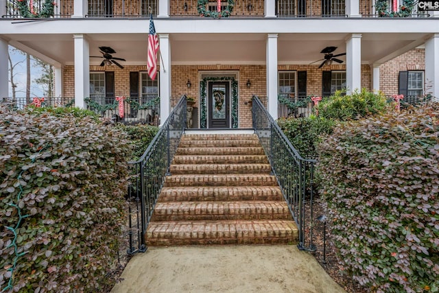 doorway to property with covered porch and ceiling fan