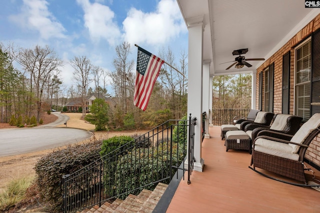 balcony featuring ceiling fan and covered porch