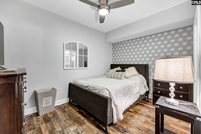 bedroom with ceiling fan and dark wood-type flooring