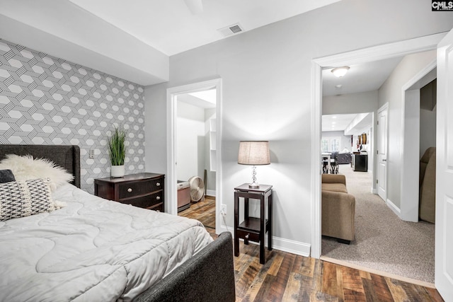 bedroom with ceiling fan and dark colored carpet