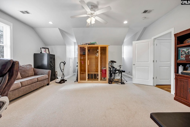 interior space featuring ceiling fan, light carpet, and vaulted ceiling