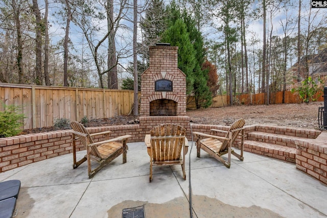 view of patio / terrace featuring an outdoor brick fireplace