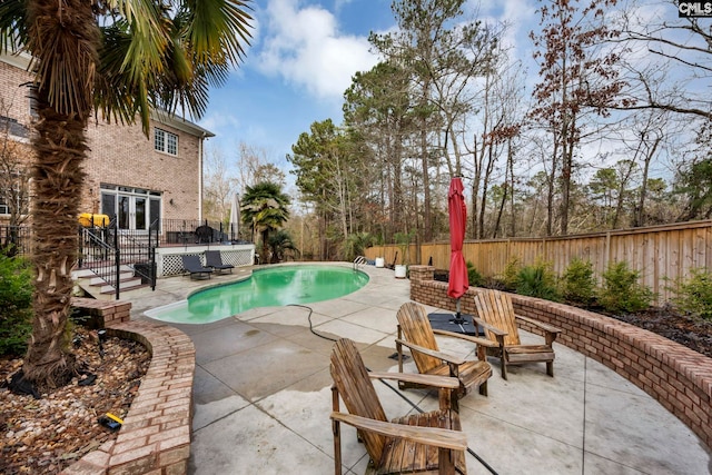 view of swimming pool featuring a patio area