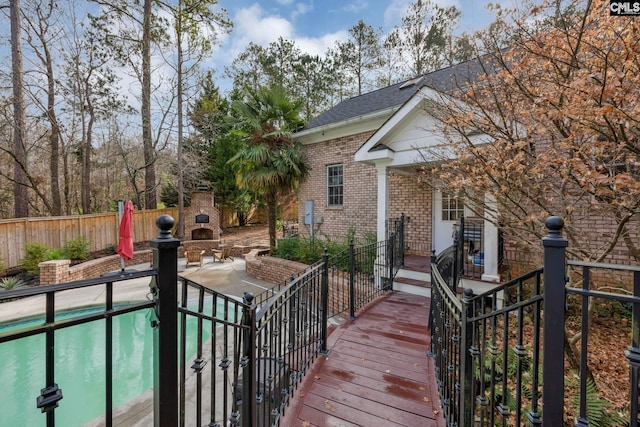 exterior space with a patio area and an outdoor stone fireplace