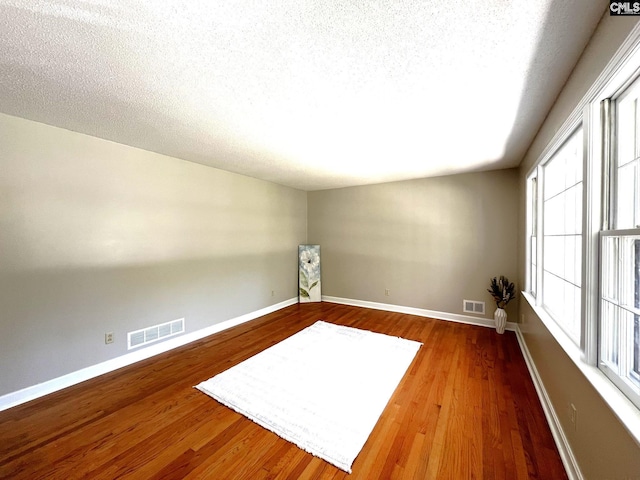 unfurnished room featuring hardwood / wood-style flooring