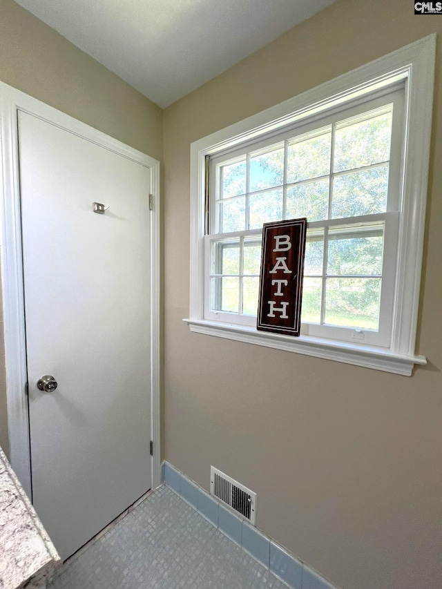 doorway to outside featuring plenty of natural light and tile patterned floors