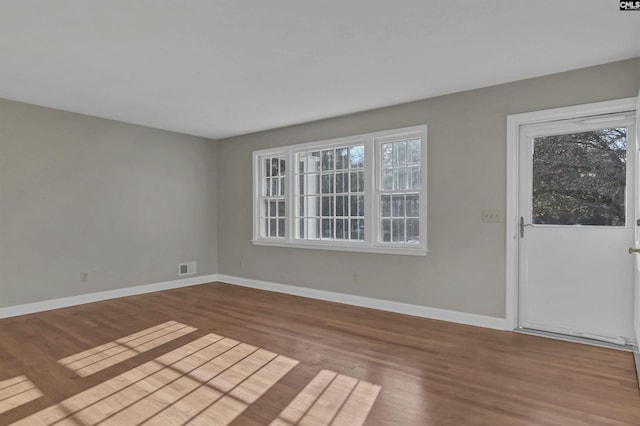 empty room with light hardwood / wood-style flooring