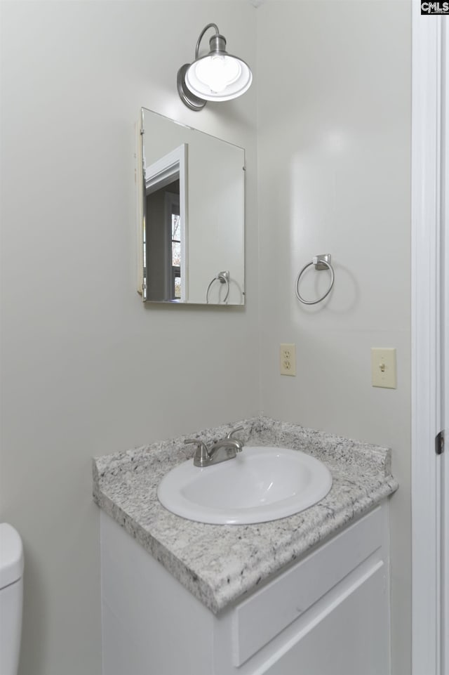 bathroom with toilet and vanity