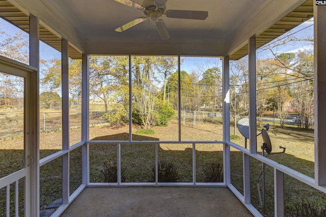 unfurnished sunroom with ceiling fan