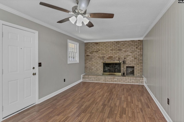 unfurnished living room featuring ceiling fan, a fireplace, hardwood / wood-style floors, a textured ceiling, and ornamental molding