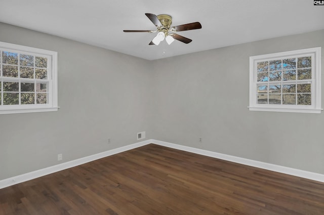 spare room featuring ceiling fan and dark hardwood / wood-style floors