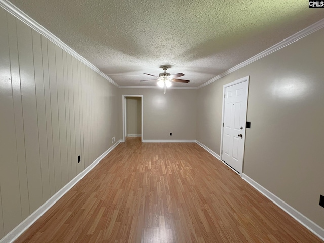 empty room featuring ceiling fan, crown molding, a textured ceiling, and light hardwood / wood-style floors