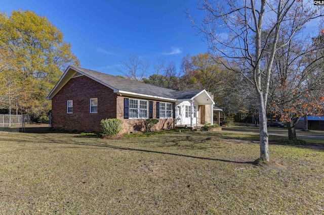 view of side of home with a lawn