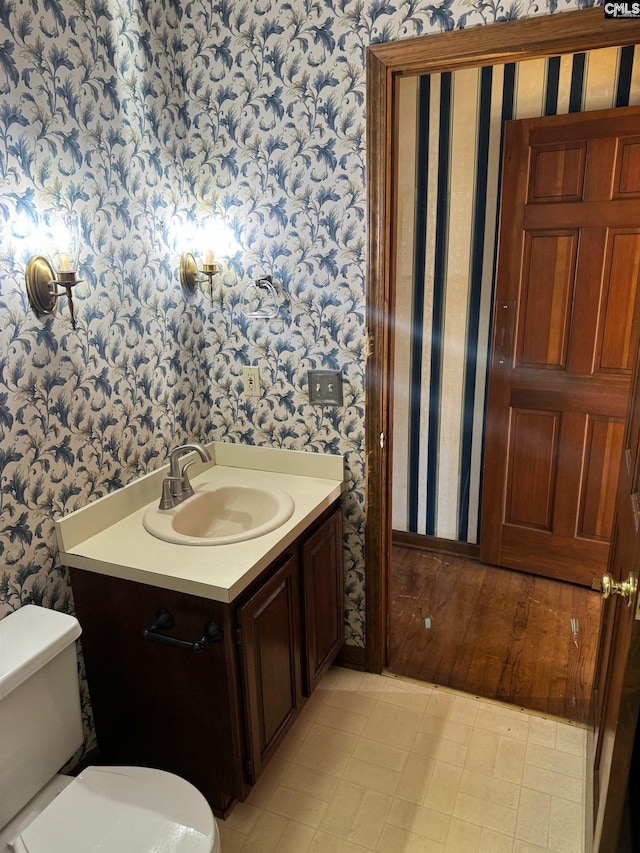 bathroom featuring toilet and vanity