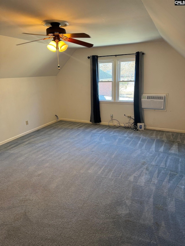 additional living space with ceiling fan, vaulted ceiling, an AC wall unit, and carpet flooring