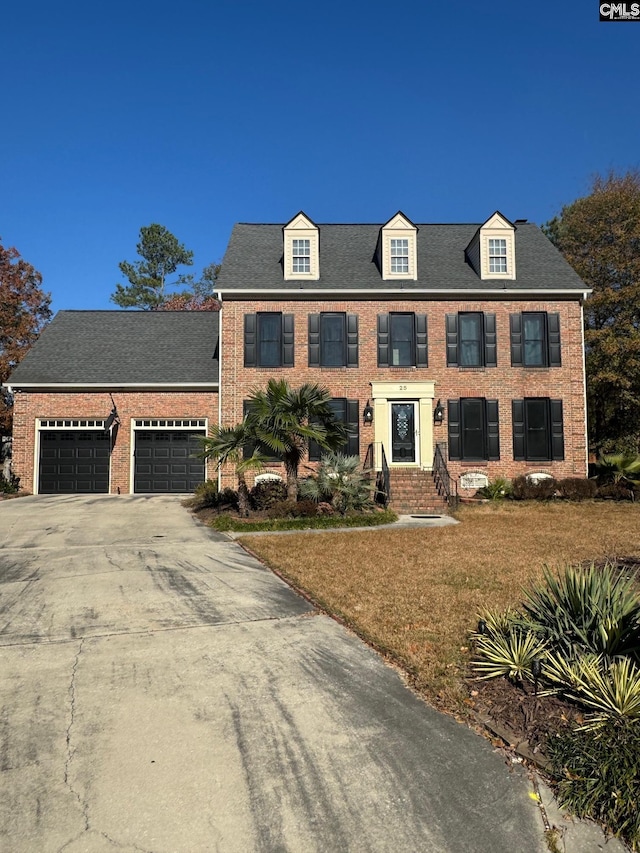 view of front of home with a garage and a front lawn