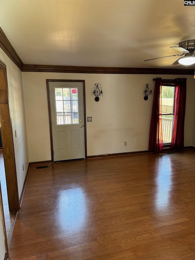 entryway featuring ceiling fan, wood-type flooring, and ornamental molding