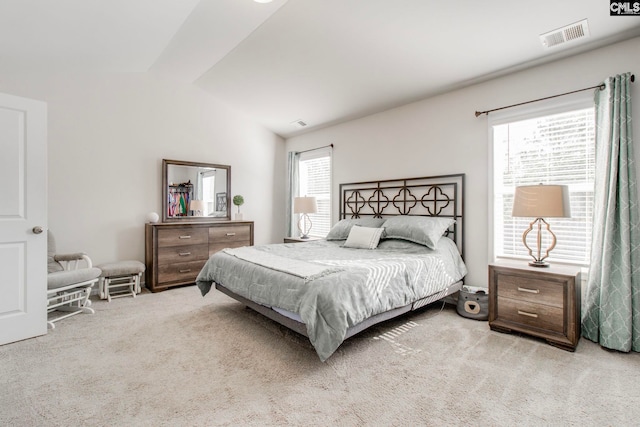 bedroom featuring light carpet and lofted ceiling