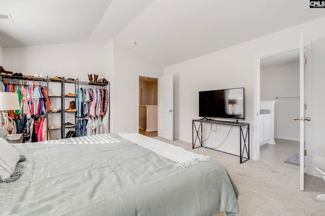 bedroom featuring light colored carpet and vaulted ceiling