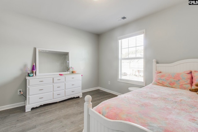 bedroom with hardwood / wood-style flooring