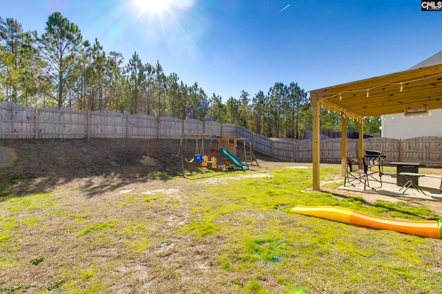 view of yard featuring a patio area and a playground