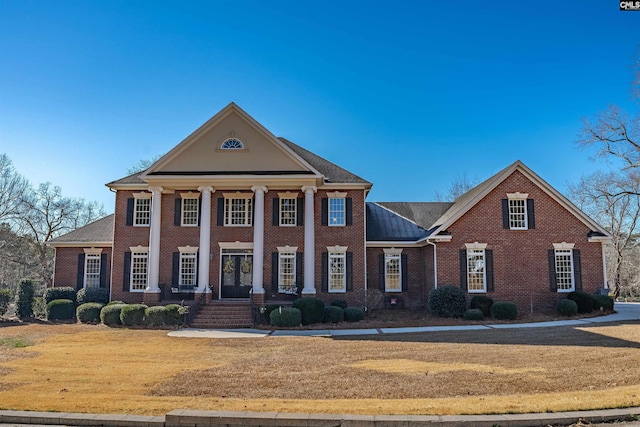 greek revival house featuring a front lawn