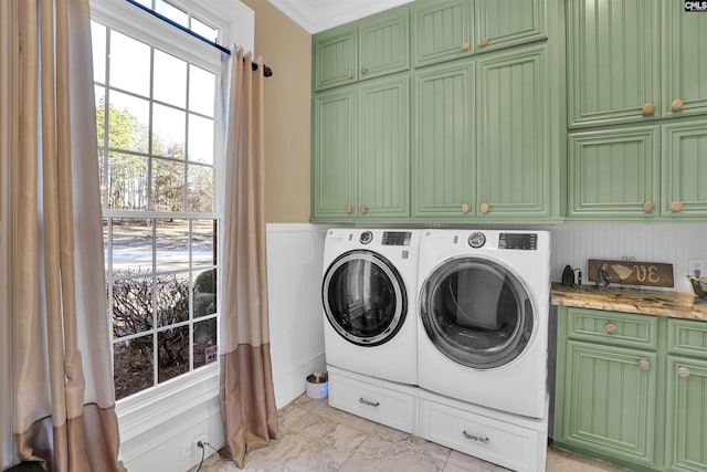 laundry room featuring cabinets and washing machine and clothes dryer