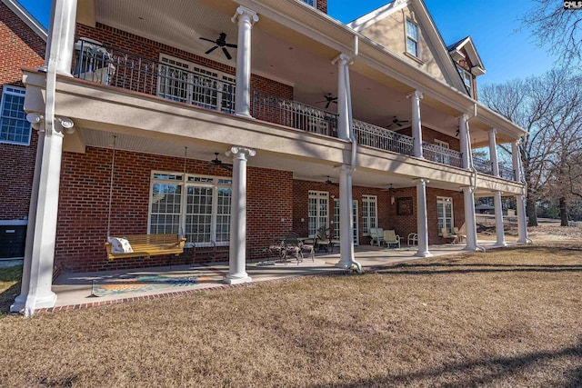 back of house featuring ceiling fan, a balcony, and a patio