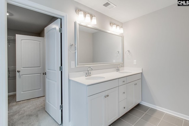 bathroom featuring tile patterned flooring and vanity