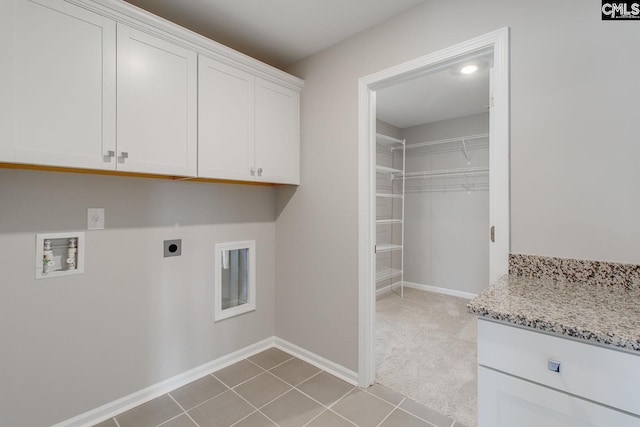 clothes washing area featuring light colored carpet, washer hookup, hookup for an electric dryer, and cabinets