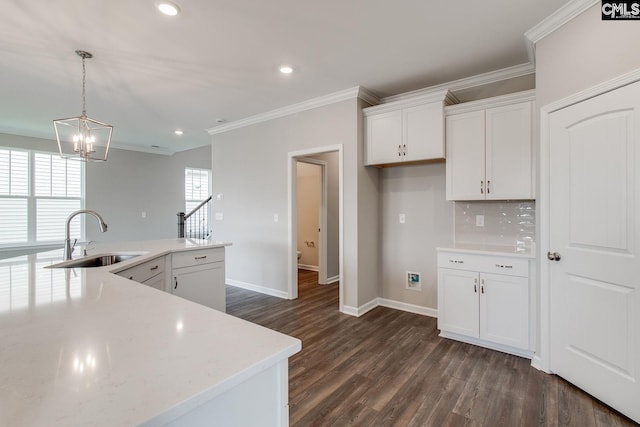 kitchen featuring tasteful backsplash, dark hardwood / wood-style floors, sink, white cabinetry, and hanging light fixtures