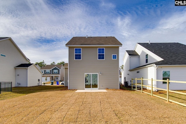 rear view of house featuring cooling unit, a patio area, a yard, and fence