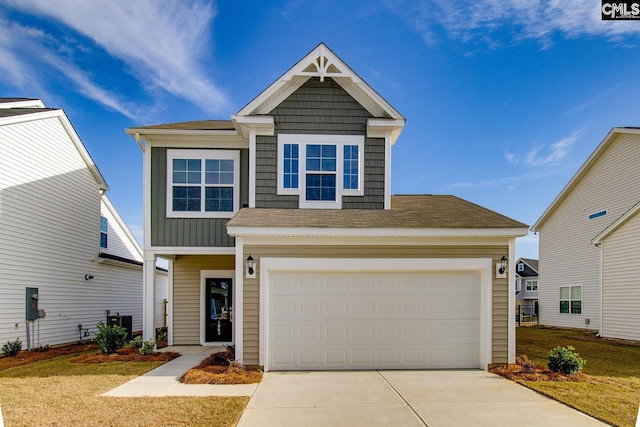 view of front of home featuring a garage, concrete driveway, a front lawn, and board and batten siding