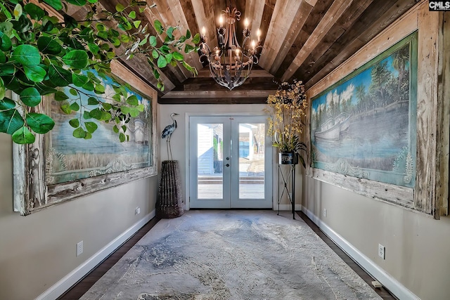 entryway with lofted ceiling, an inviting chandelier, wood ceiling, dark wood-type flooring, and french doors