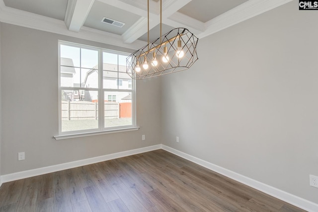 empty room featuring dark wood-style flooring, visible vents, and baseboards