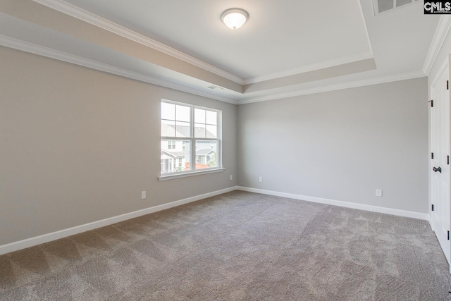 carpeted spare room featuring visible vents, baseboards, a raised ceiling, and ornamental molding