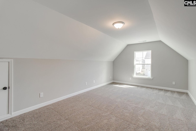 bonus room with carpet, vaulted ceiling, and baseboards