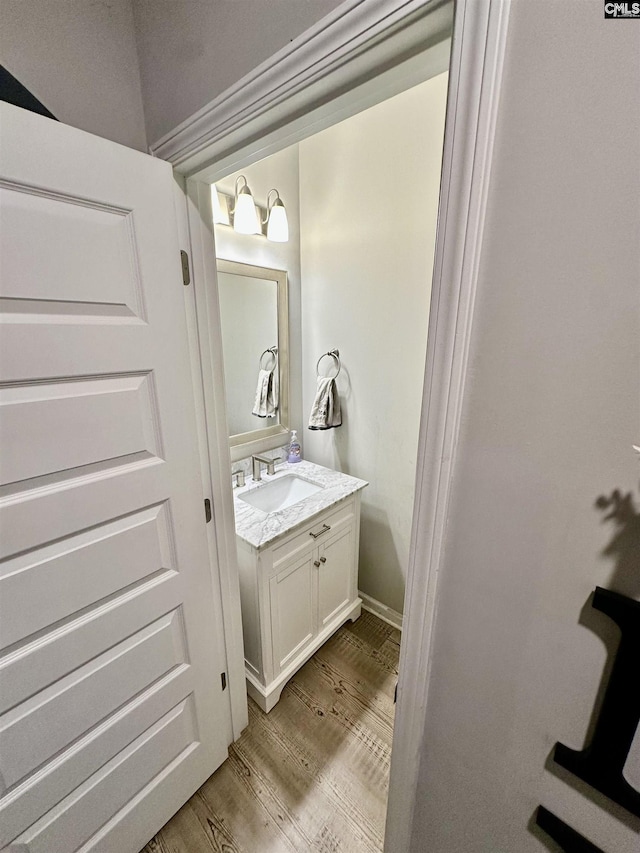 bathroom with hardwood / wood-style flooring and vanity