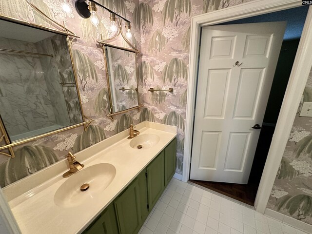 bathroom featuring vanity, tile patterned flooring, and a tile shower