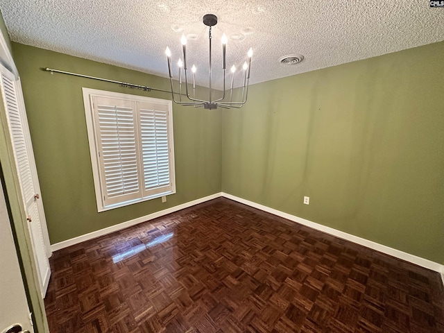 unfurnished dining area featuring parquet floors and a textured ceiling