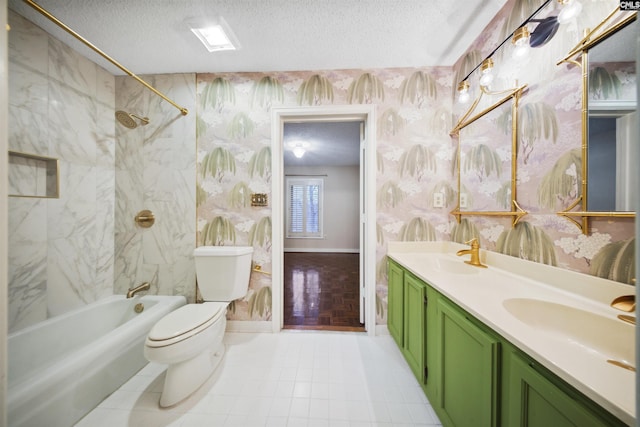 full bathroom featuring tiled shower / bath combo, vanity, a textured ceiling, and toilet