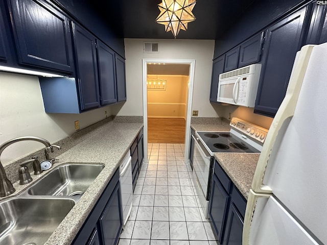 kitchen with sink, white appliances, blue cabinetry, and a chandelier