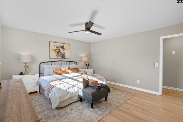 bedroom with ceiling fan and light hardwood / wood-style floors