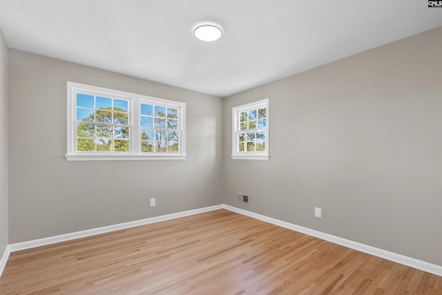 empty room with light hardwood / wood-style flooring