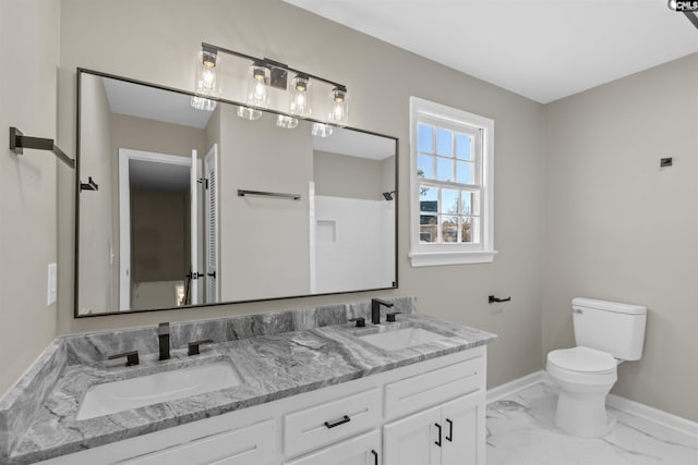 bathroom featuring toilet, a shower, and vanity