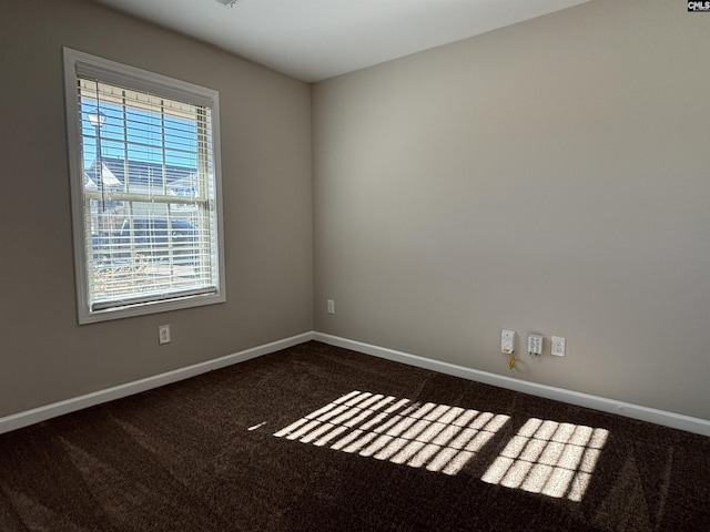 carpeted spare room featuring a healthy amount of sunlight